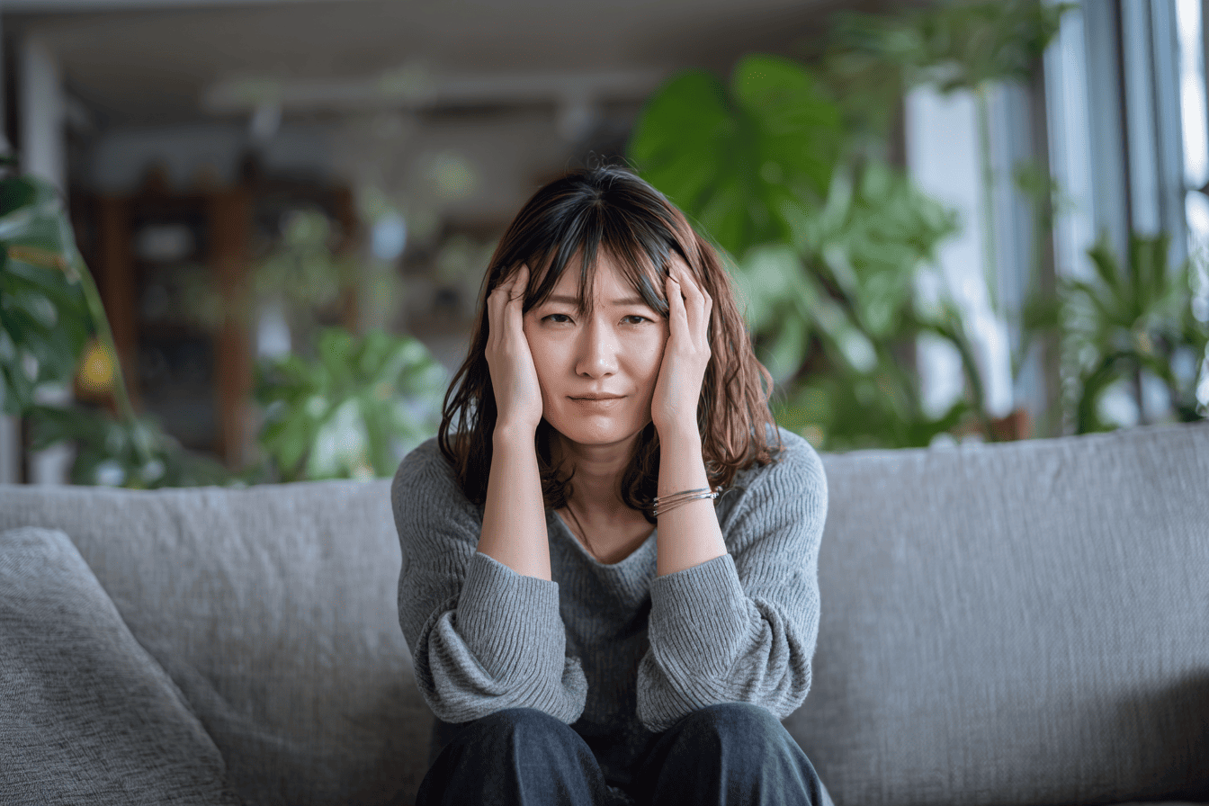 頭を抱えて悩む女性